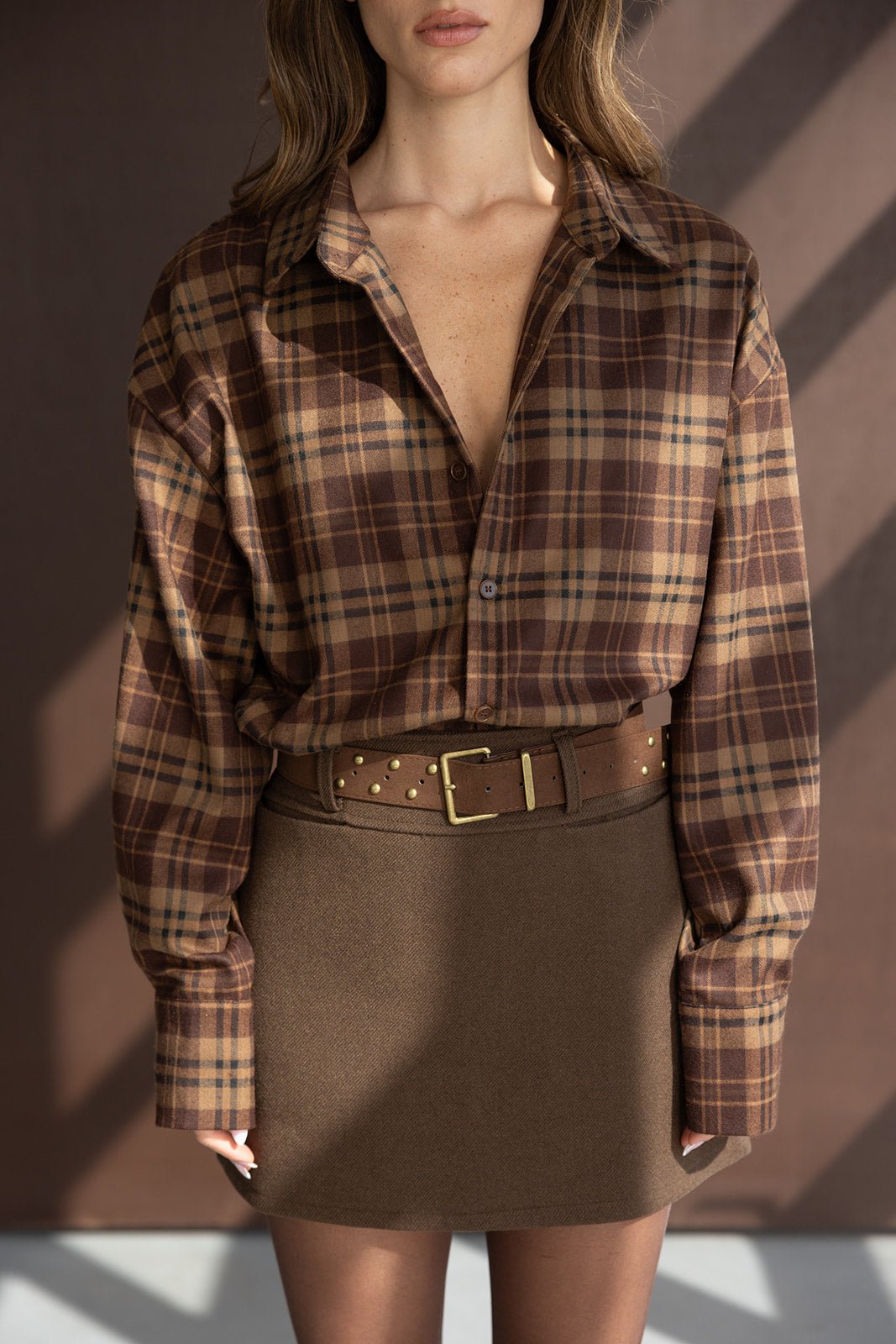חולצת פלנל משובצת חום בשילוב חצאית וחגורת ניטים, אופנה לנשים צעירות