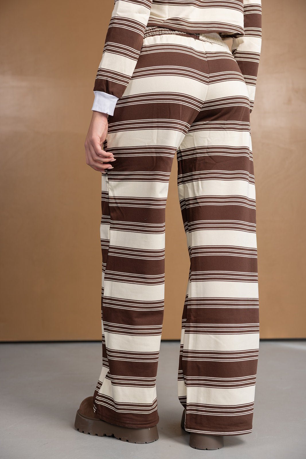 מכנסיים רחבים לנשים בדוגמת פסים חומים ולבנים, מראה אופנתי ועדכני