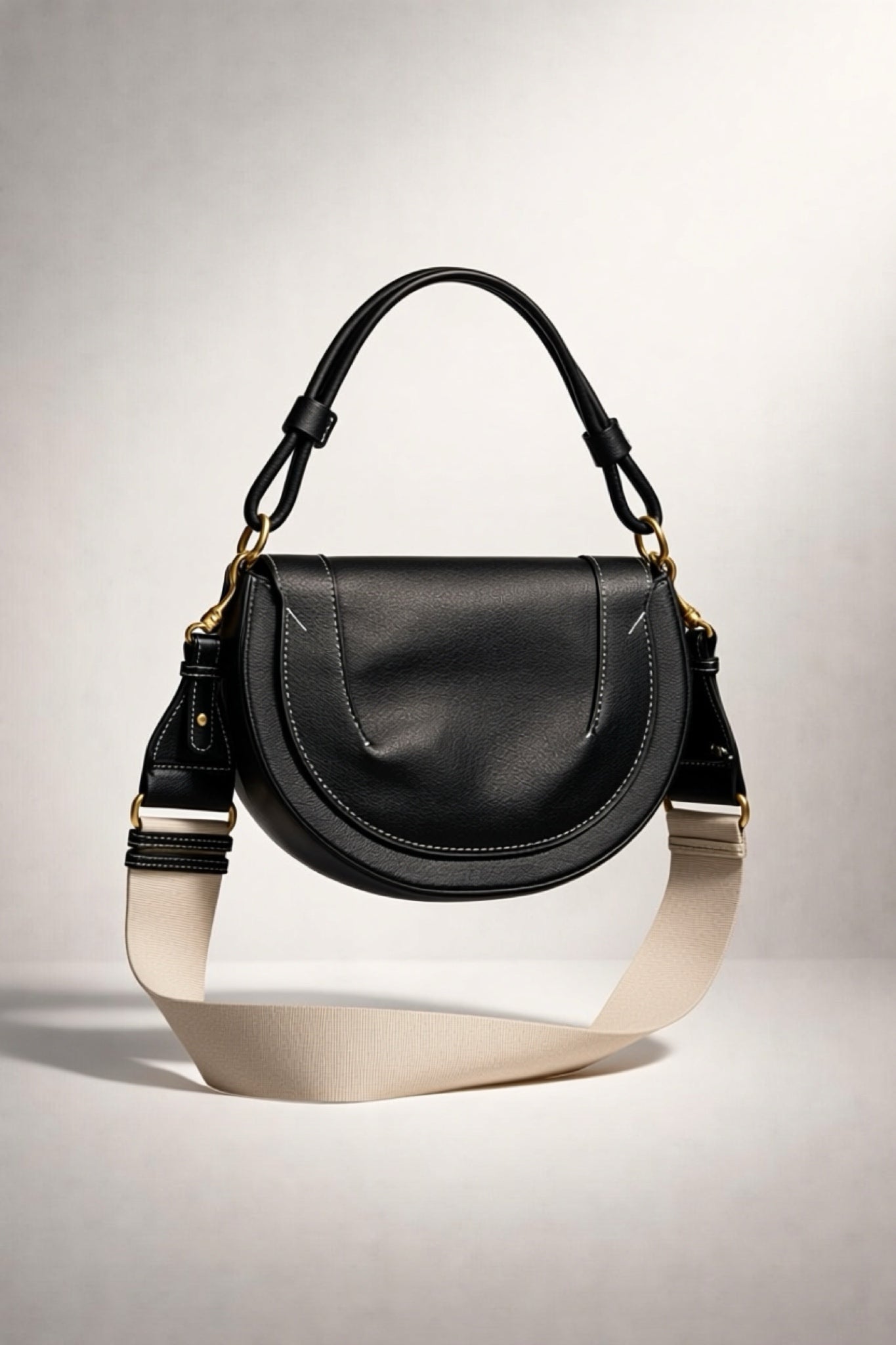 תיק צד נשים אופנתי מעור מלאכותי בצבע שחור עם רצועת בד עבה בהירה, מתאים לאופנת קיץ וסתיו