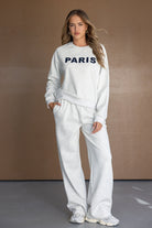 דוגמנית לובשת סט טרנינג אפור לנשים עם הדפס PARIS, בגדי אופנה לנשים, צילום בסטודיו