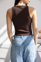 דוגמנית עם גופיית ריב חומה ומכנסי ג'ינס רחבים לאישה, אופנה טרנדית קיץ