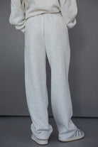 טרנינג נשים אפור בהיר במראה רחב ונוח, עם גומי במותן ונעלי ספורט אופנתיות