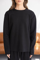 חולצת נשים שחורה עם שרוולים ארוכים, עיצוב מינימליסטי, אופנת חורף לנשים